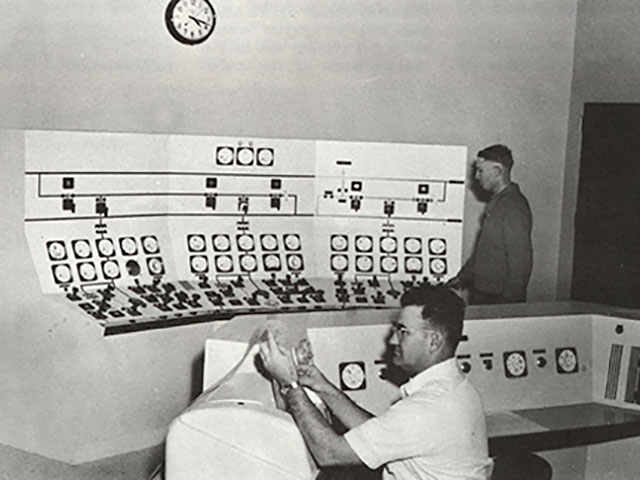 Employees working in control room