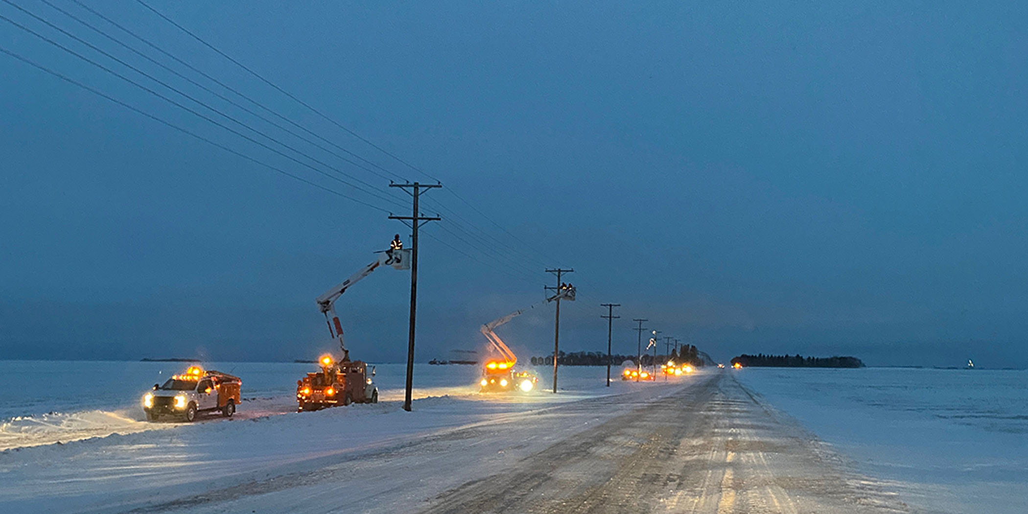 SaskPower bucket trucks repairing power lines