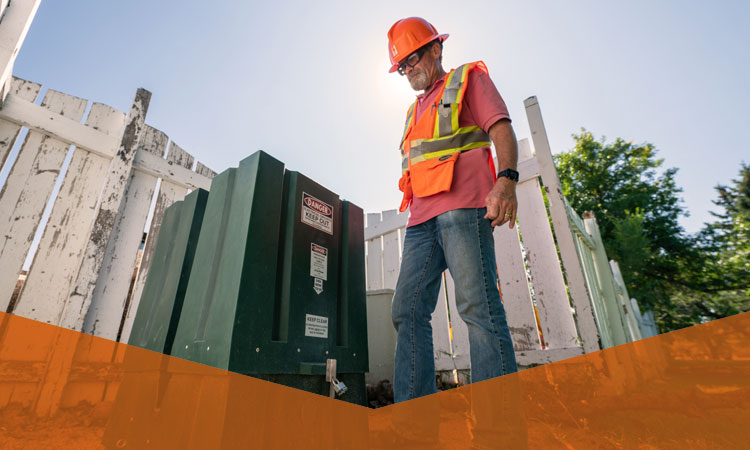 Man standing near power transformer