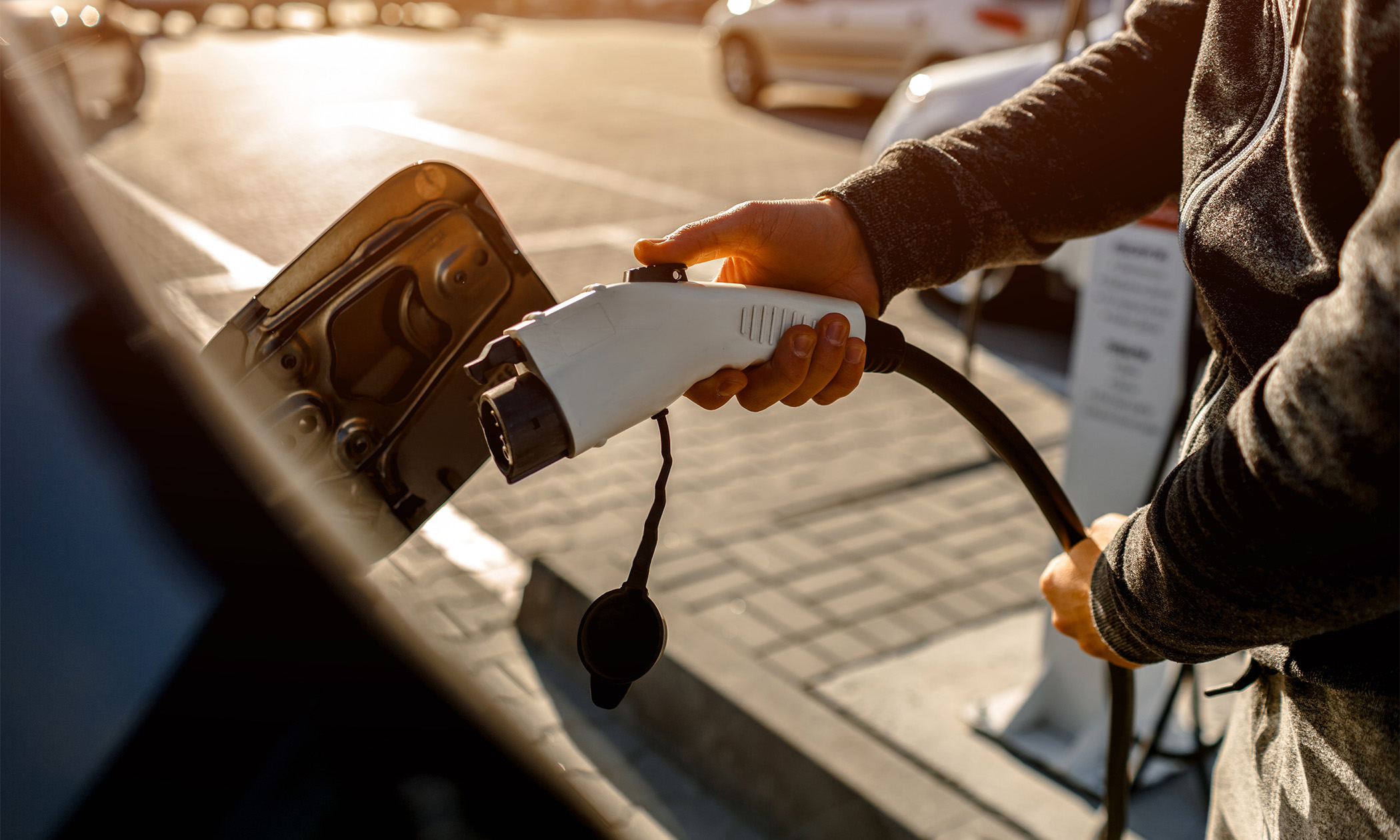 Person plugging their EV car into a charger