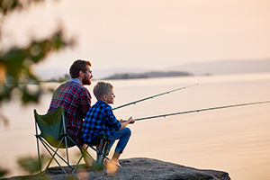 Father and sun fishing on a lake.