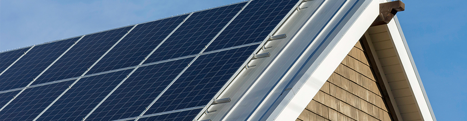 The roof of a home with solar panels on the side.